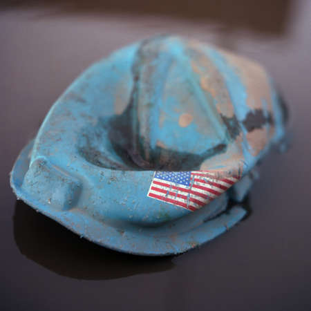 Crushed hard hat with american flag