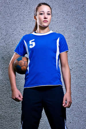 Portrait of young woman holding handball