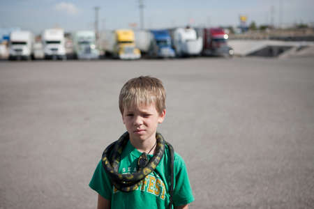 Boy with snake around his neck