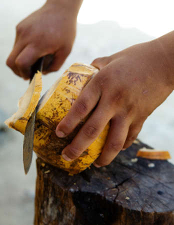 Man cutting coconut