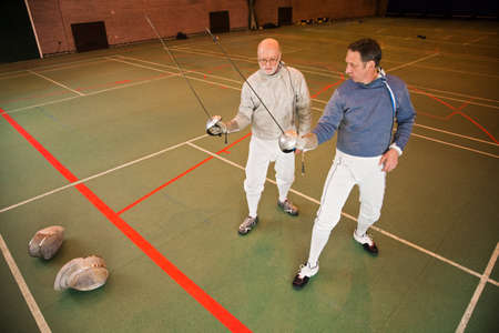 Senior and mature men fencing together
