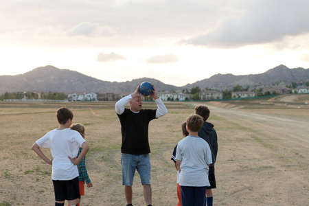 Soccer coach mentoring boysの写真素材