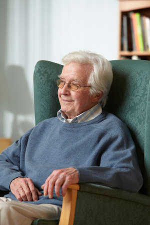 Senior man in armchair, portrait