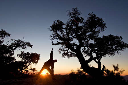 Man stretching at sunrise in Death Valley National Park, California, USAの写真素材
