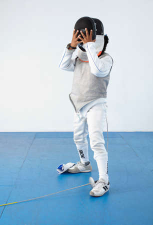 Girl adjusting fencing maskの写真素材