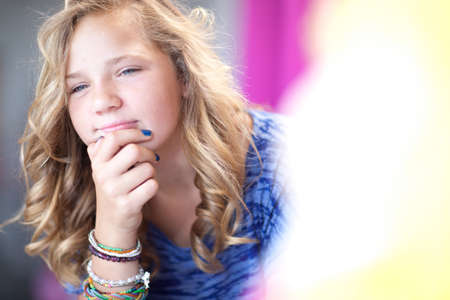 Girl thinking with chin in hand