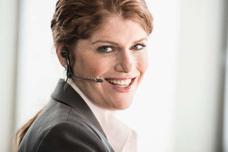 Smiling businesswoman wearing headset
