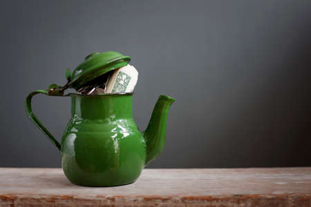 Teapot with dollar notes inside