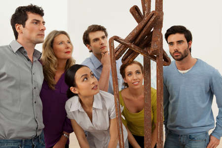 Visitors looking at sculpture in art galleryの写真素材