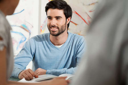 Young man smiling in gallery