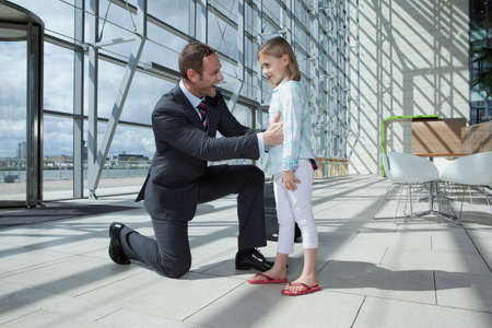 Father arriving in airport with daughterの写真素材