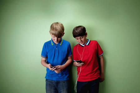 Two boys with mp3 playersの写真素材