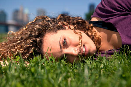 Young woman lying on grassの写真素材