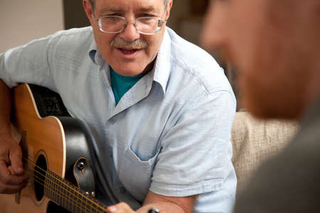 Mature man playing guitar