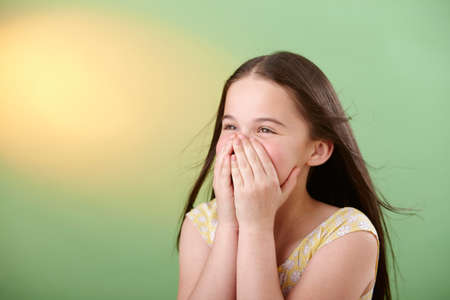 Girl covering mouthの写真素材