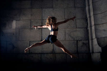 Woman jumping with legs and arms open