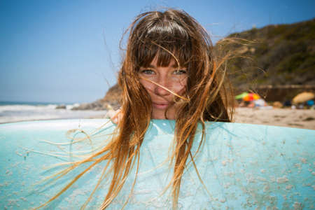 Young woman with surfboard