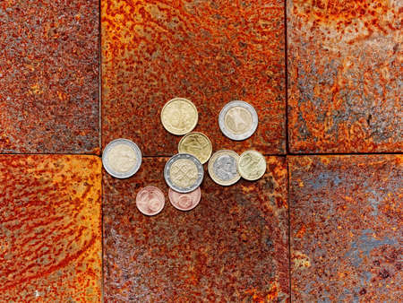 Euro coins on brick floor