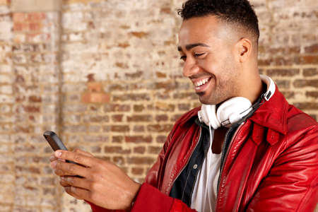 Smiling man using cell phone