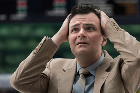 Stressed businessman at stock exchange