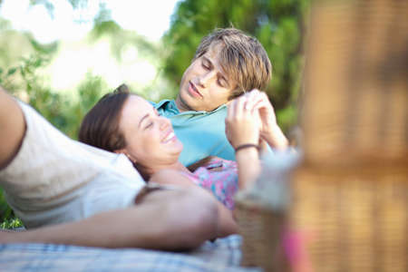 Couple relaxing on picnic blanketの写真素材