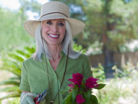 Older woman gardening outdoorsの写真素材