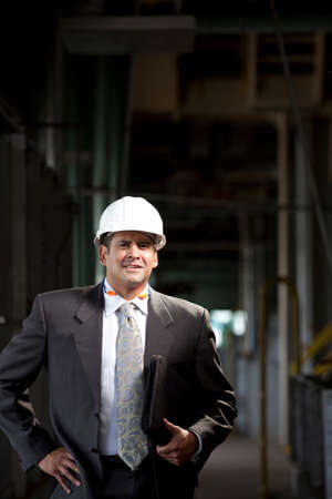 Businessman carrying folder in plantの写真素材