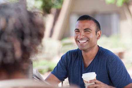 Couple having coffee together outdoors