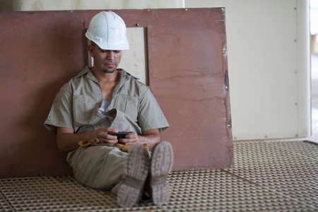 Industrial worker using cell phoneの写真素材
