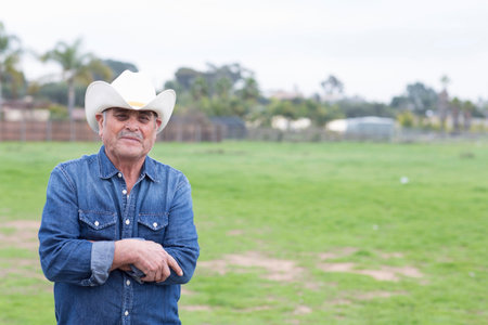 Farmer smiling in grassy fieldの写真素材
