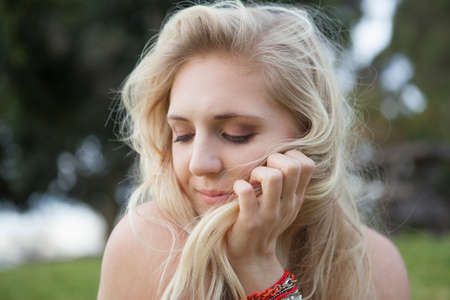 Smiling woman sitting in field