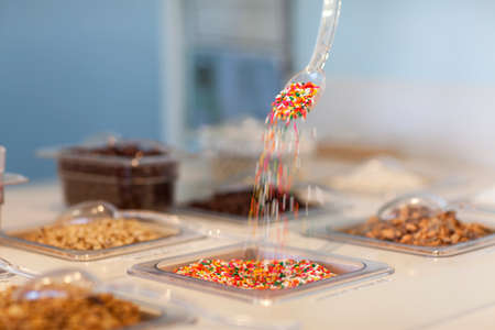 Sprinkles pouring from spoon in display