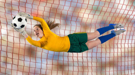 Soccer player catching ball in airの写真素材