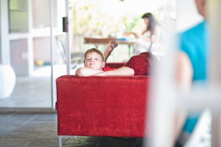 Boy lying on sofa