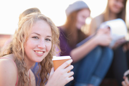 Young woman holding coffeeの写真素材