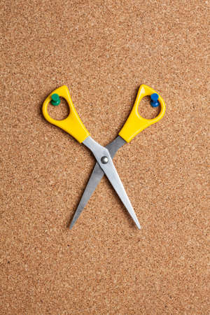 Pair of scissors on cork boardの写真素材