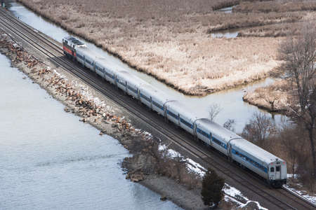 Aerial view of train travelling though countrysideの写真素材