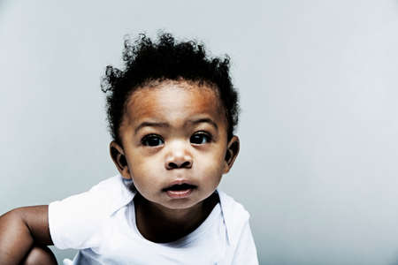 Portrait of baby boy wearing white vestの写真素材