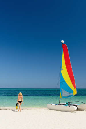 Woman on beach, Grace Bay, Providenciales, Turks and Caicos, Caribbeanの写真素材