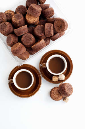 Fresh coffee in cups with cakes, studio shotの写真素材