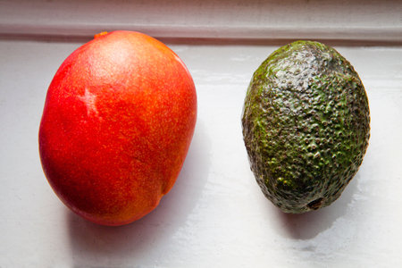 Overhead view of red and green avocadosの写真素材