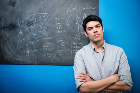 Businessman in front of blackboard