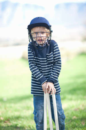 Boy in cricket helmet