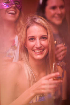 Young woman with blonde hair holding wine glassの写真素材