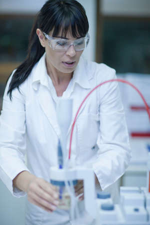 Oenologist monitoring sample testing in laboratory