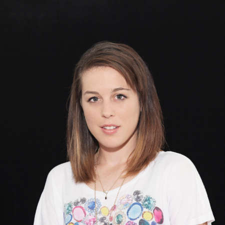 Portrait of young woman against black background