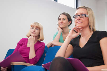 Women listening to presentationの写真素材