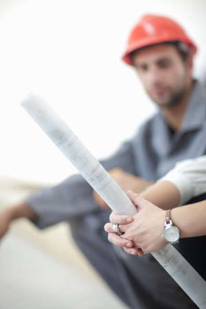 Female architect  holding blueprint