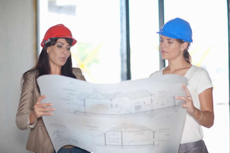 Architect and project manager looking at blueprintの写真素材