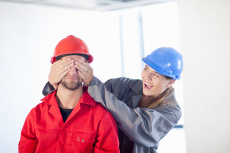 Young couple fooling around on construction site